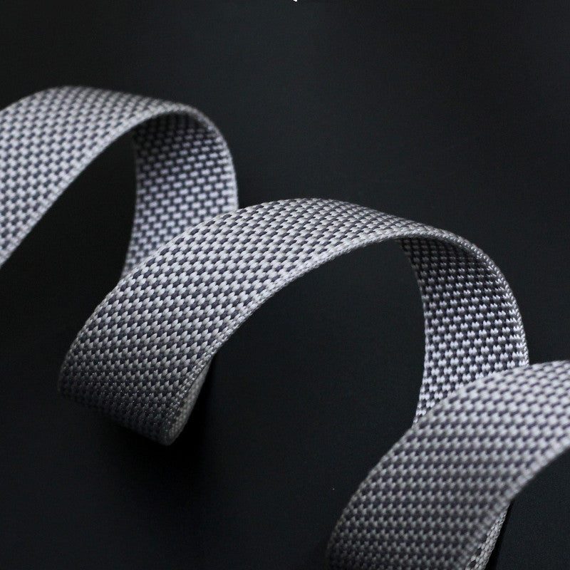 Close-up of a textured gray ribbon on a black background