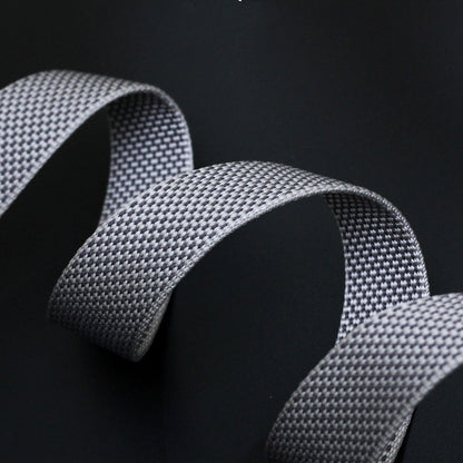 Close-up of a textured gray ribbon on a black background